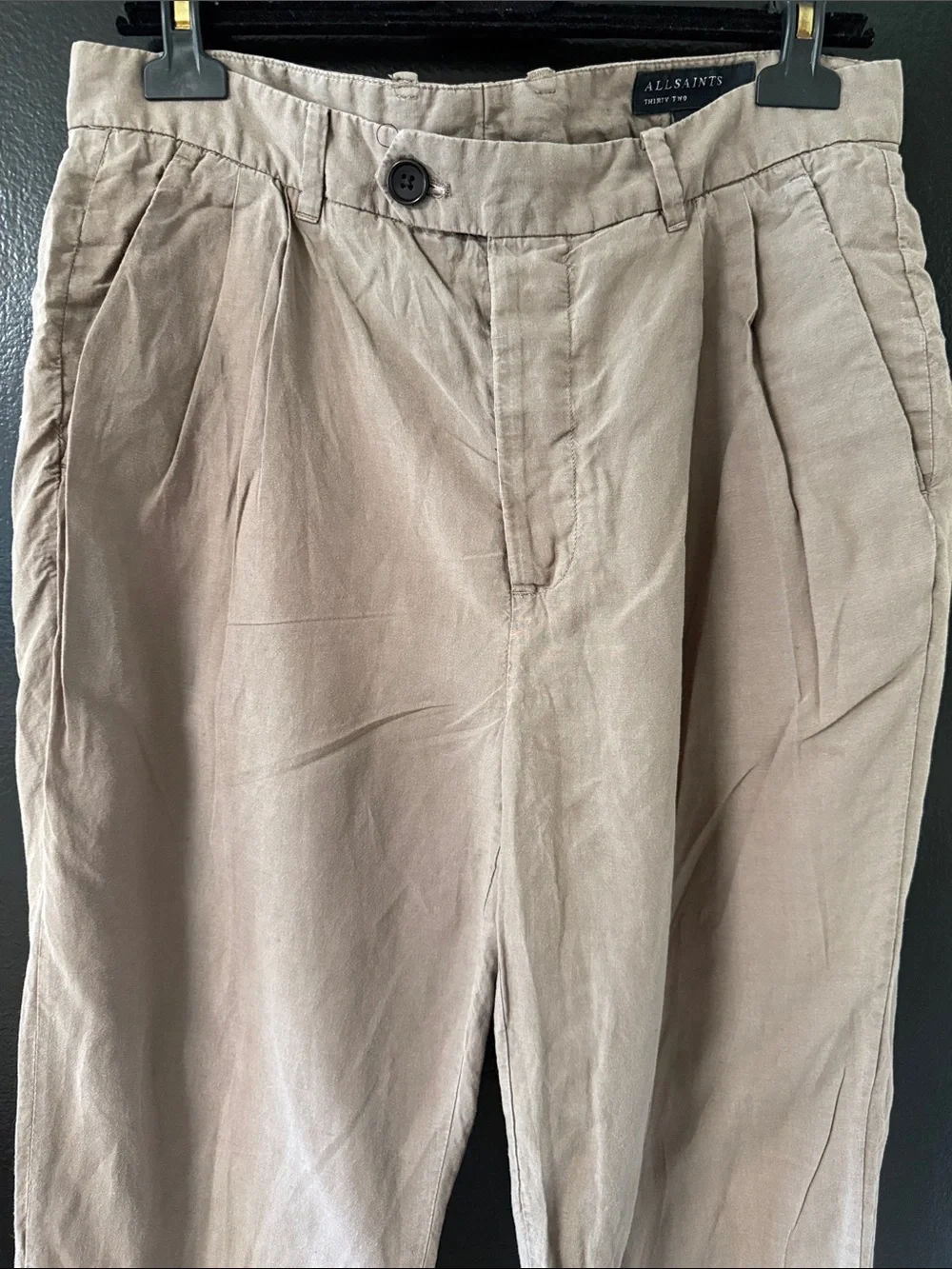 AllSaints trousers with a pleated front and a button closure